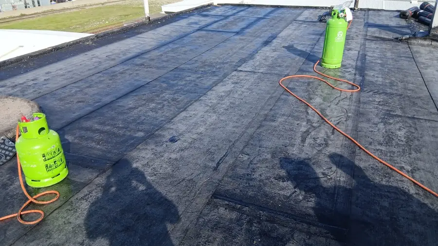 Completed torch-on waterproofing membrane on a commercial flat roof