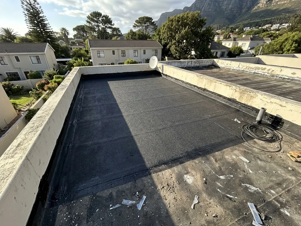 Flat-roof waterproofing system installed for a Cape Town home — engineered for wind-driven winter rain